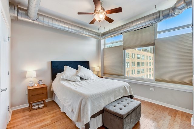 909 West Washington Boulevard, Unit 704 Chicago, IL 60607 - Photo 15 of 36 a bedroom with a bed and a large window