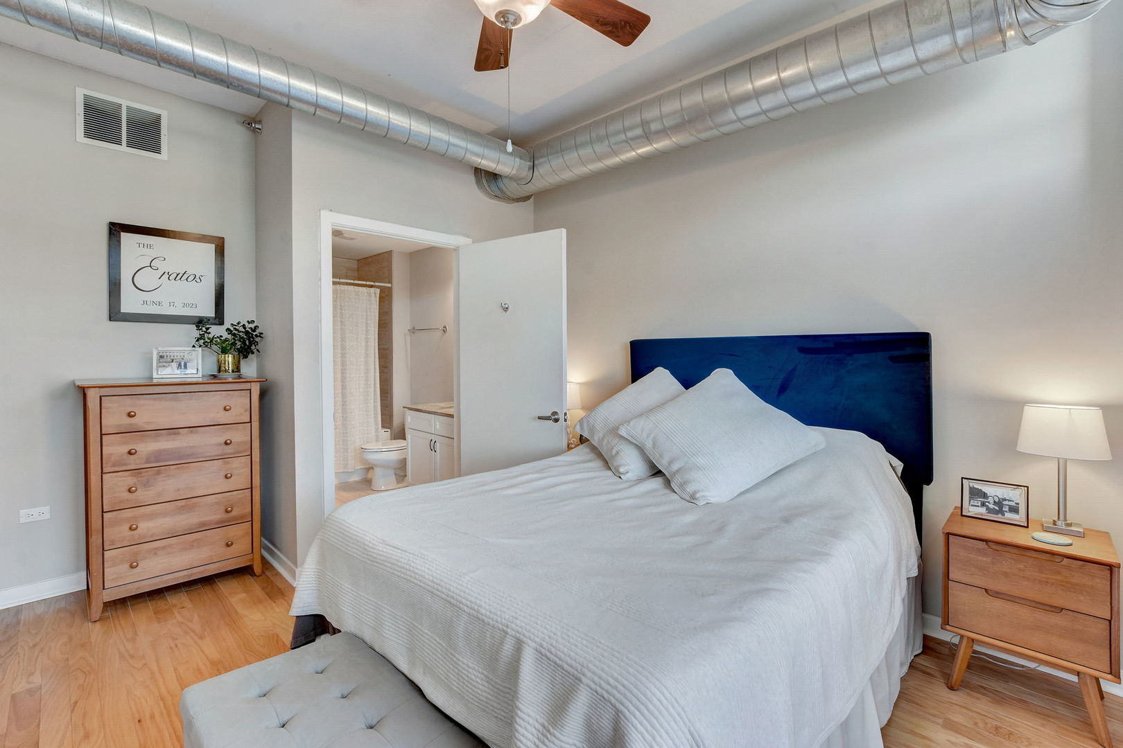 909 West Washington Boulevard, Unit 704 Chicago, IL 60607 - Photo 16 of 36 a bedroom with a bed and a dresser