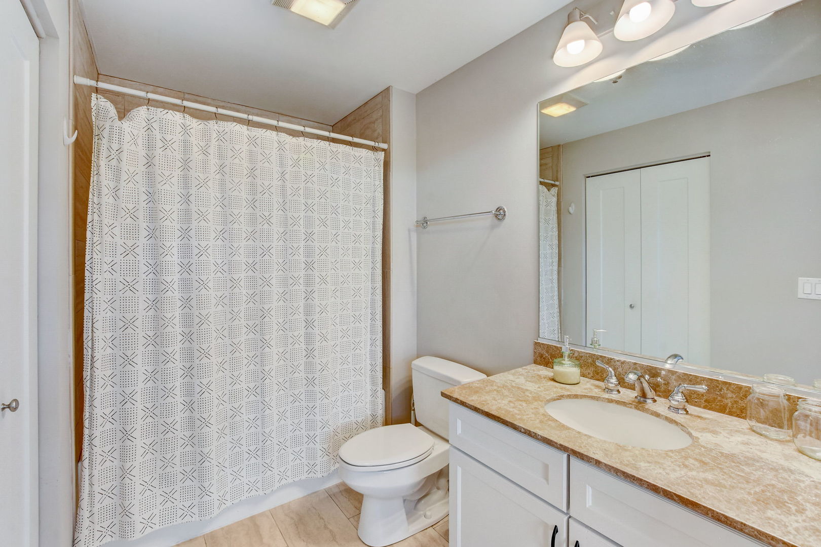 909 West Washington Boulevard, Unit 704 Chicago, IL 60607 - Photo 17 of 36 a bathroom with a granite countertop sink toilet and a mirror