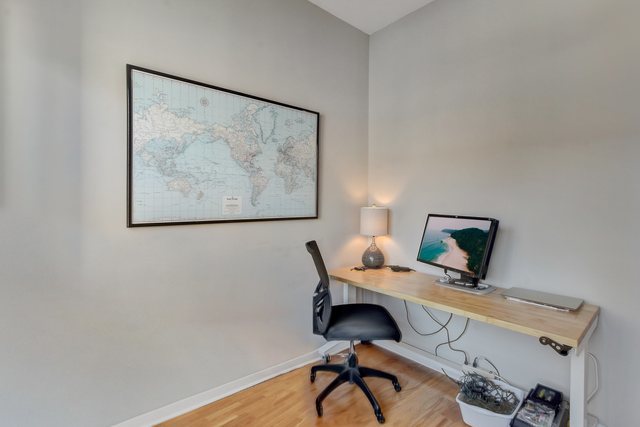 909 West Washington Boulevard, Unit 704 Chicago, IL 60607 - Photo 21 of 36 a view of a workspace with furniture and wooden floor