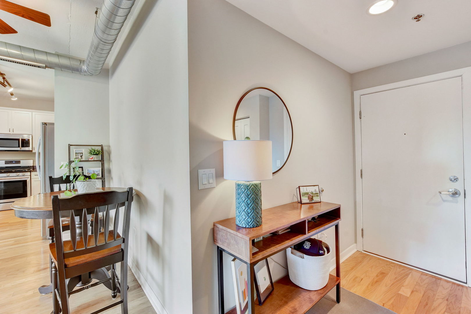 909 West Washington Boulevard, Unit 704 Chicago, IL 60607 - Photo 6 of 36 a view of a workspace room with furniture and wooden floor