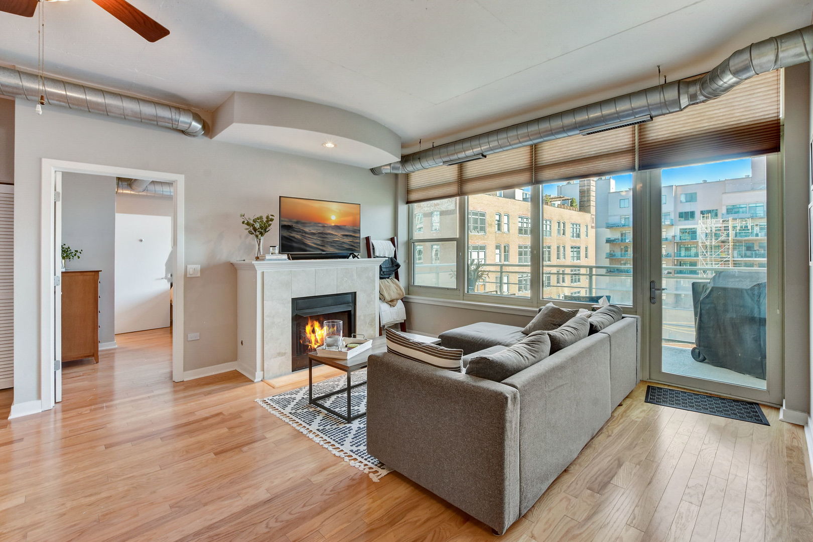 909 West Washington Boulevard, Unit 704 Chicago, IL 60607 - Photo 7 of 36 a living room with furniture and a fireplace
