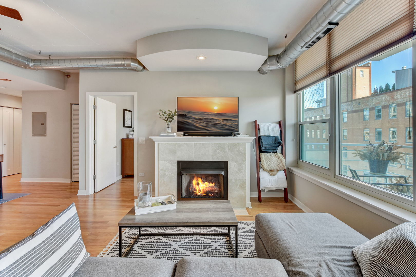 909 West Washington Boulevard, Unit 704 Chicago, IL 60607 - Photo 8 of 36 a living room with furniture and a fireplace