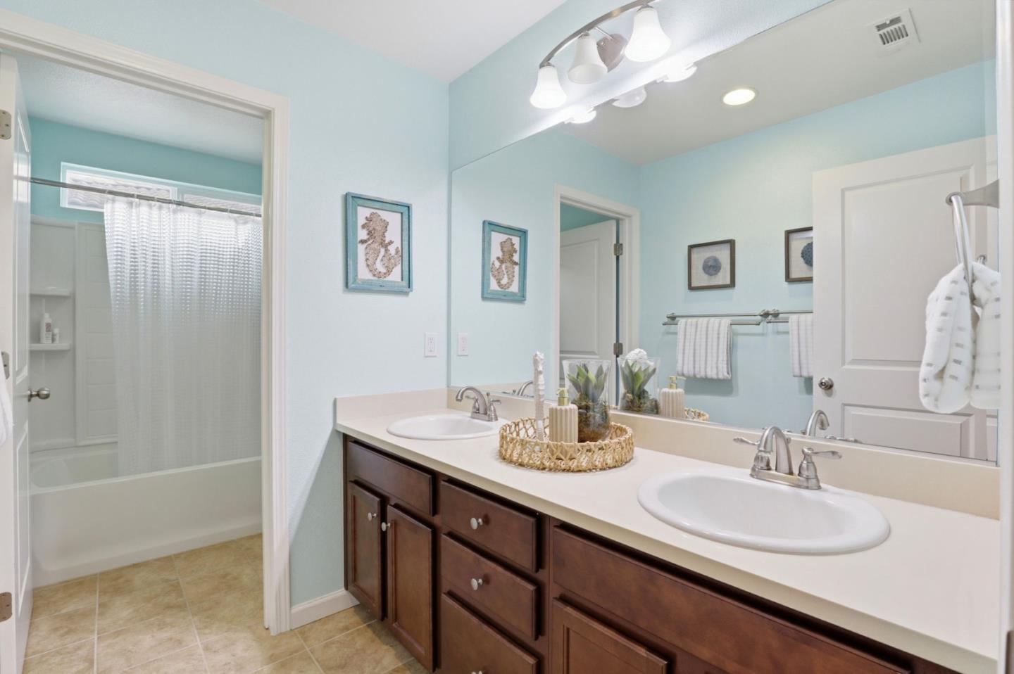 301 Promise Way Hollister, CA 95023 - Photo 13 of 22 a bathroom with a sink a vanity and a mirror