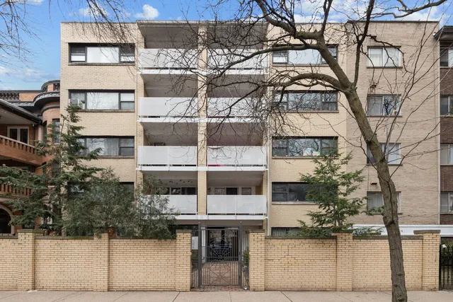 a view of a kitchen with stainless steel appliances a refrigerator and cabinets