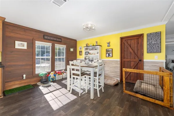 a large white kitchen with stainless steel appliances granite countertop a stove and a sink