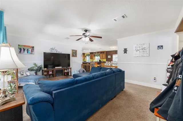 a living room with furniture a dining table and a fireplace