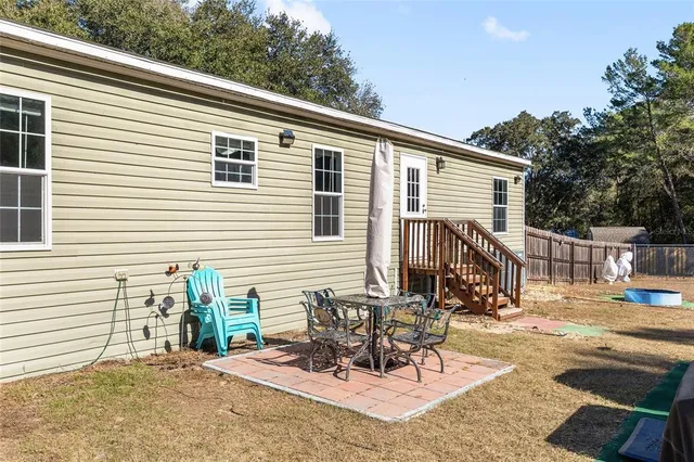 a view of yard with swimming pool and trees