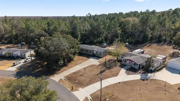 an aerial view of a house with a yard and lake view