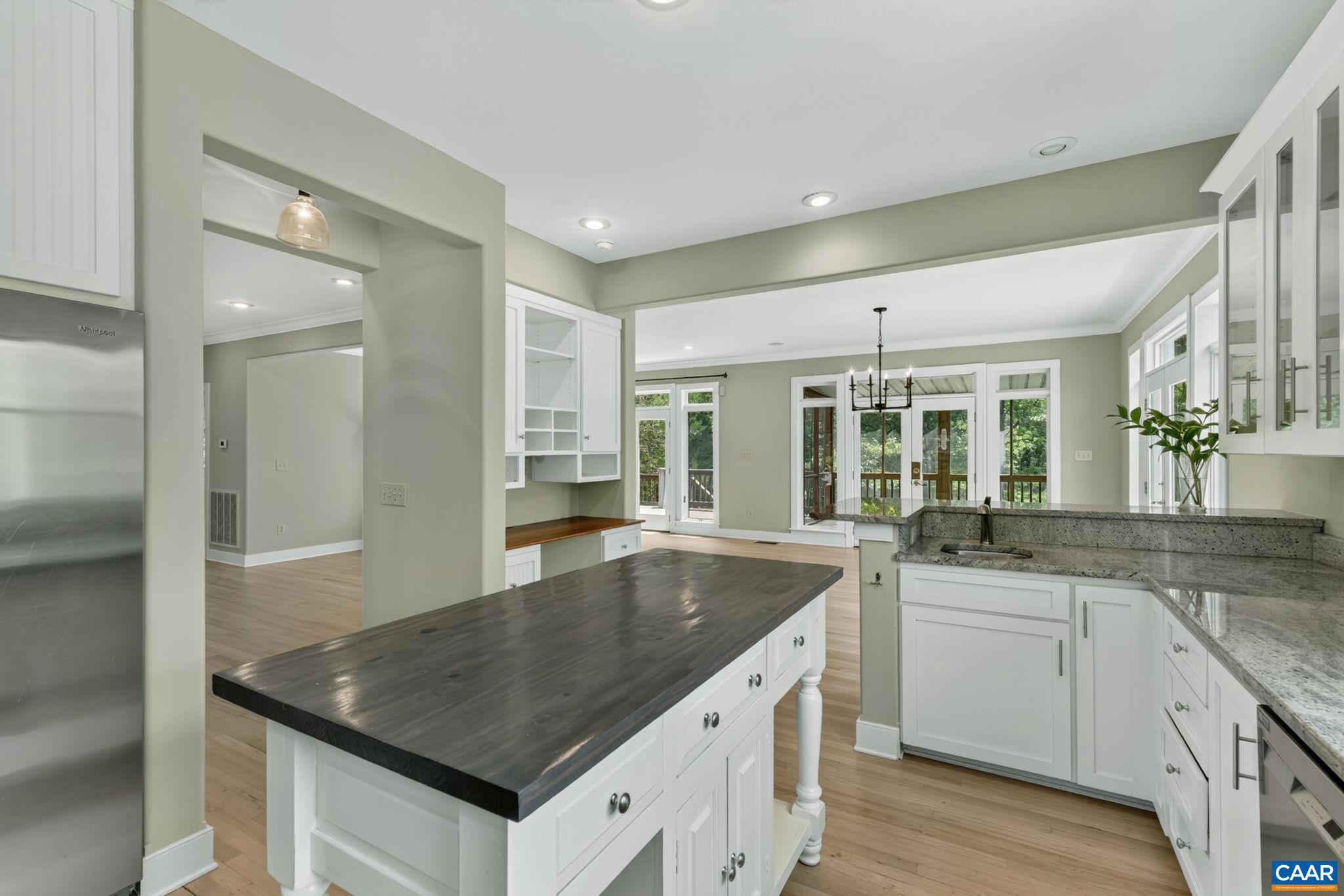 6285 Jarmans Gap Road Crozet, VA 22932 - Photo 5 of 65 a kitchen with granite countertop a sink and dishwasher with white cabinets