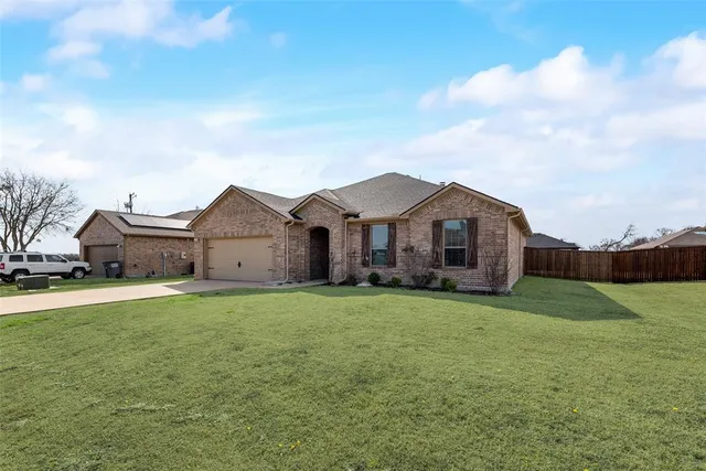 a front view of a house with yard and porch