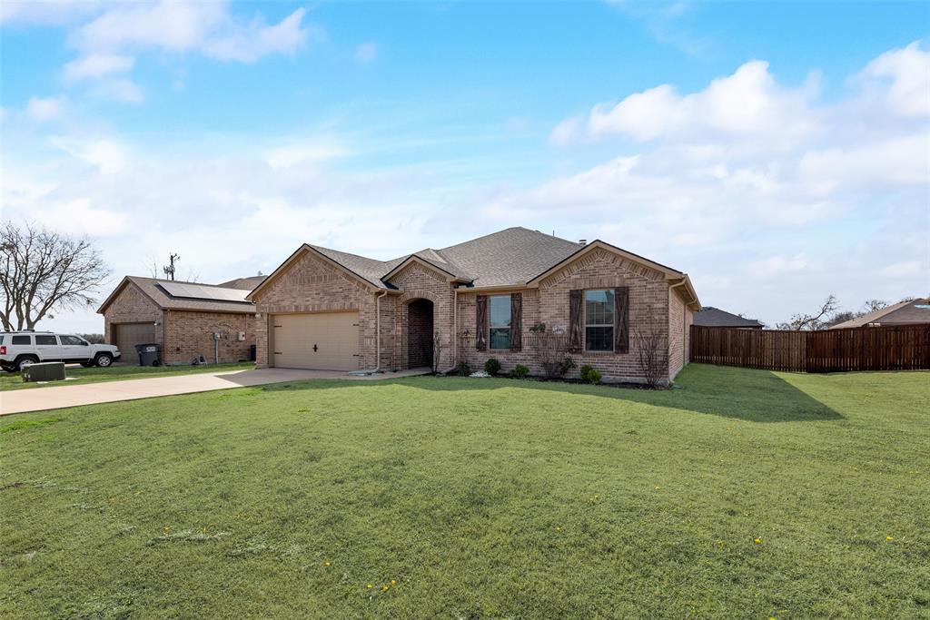 a front view of a house with yard and porch