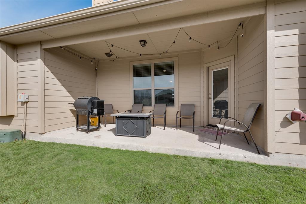 480 Collin Street Nevada, TX 75173 - Photo 24 of 27 a view of a patio with table and chairs and wooden fence