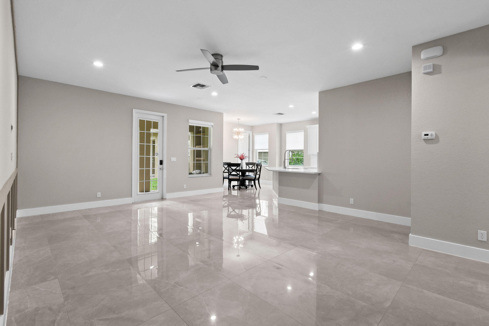 111 Tullamore Avenue Jupiter, FL 33458 - Photo 15 of 63 a view of a livingroom with furniture a ceiling fan and window
