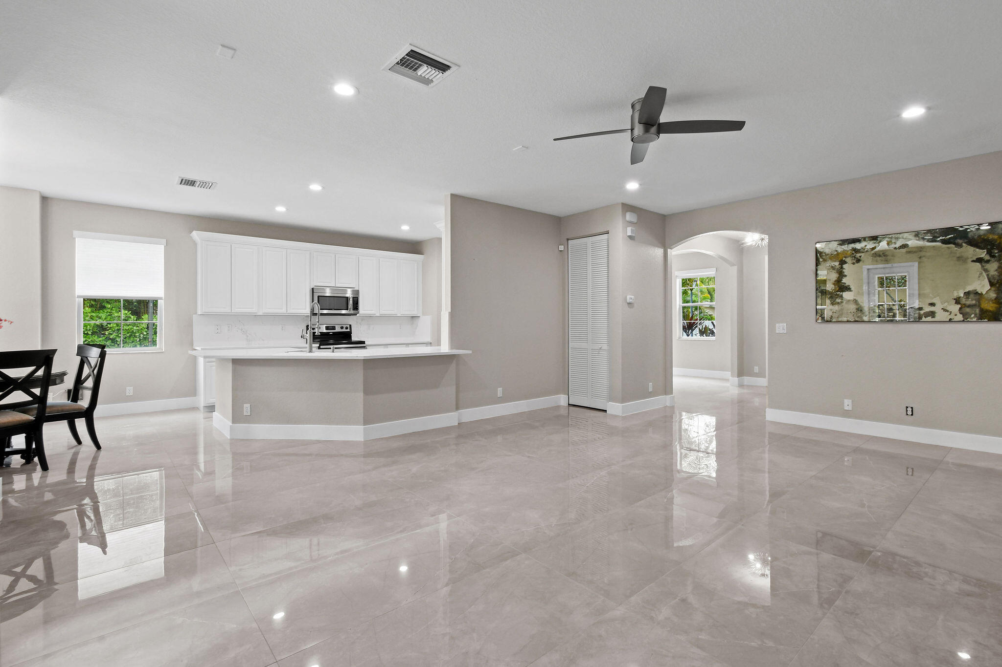 111 Tullamore Avenue Jupiter, FL 33458 - Photo 17 of 63 a view of a kitchen with refrigerator and windows