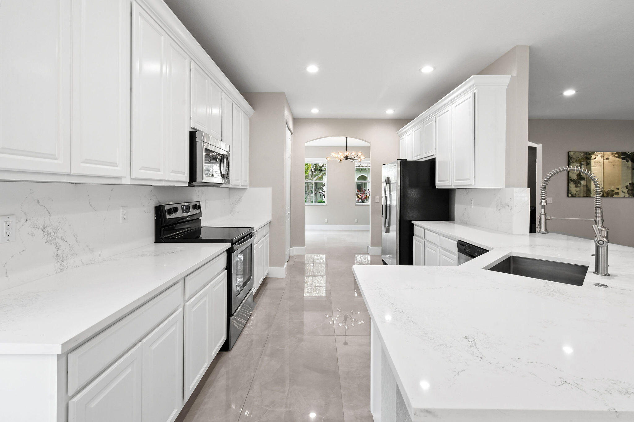 111 Tullamore Avenue Jupiter, FL 33458 - Photo 19 of 63 a kitchen with stainless steel appliances kitchen island granite countertop a sink and cabinets