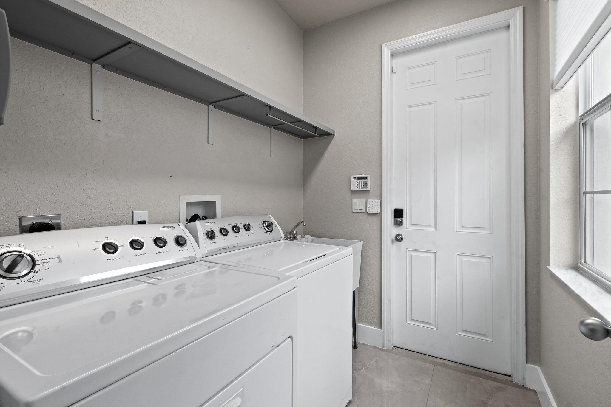 111 Tullamore Avenue Jupiter, FL 33458 - Photo 24 of 63 a utility room with dryer and washer