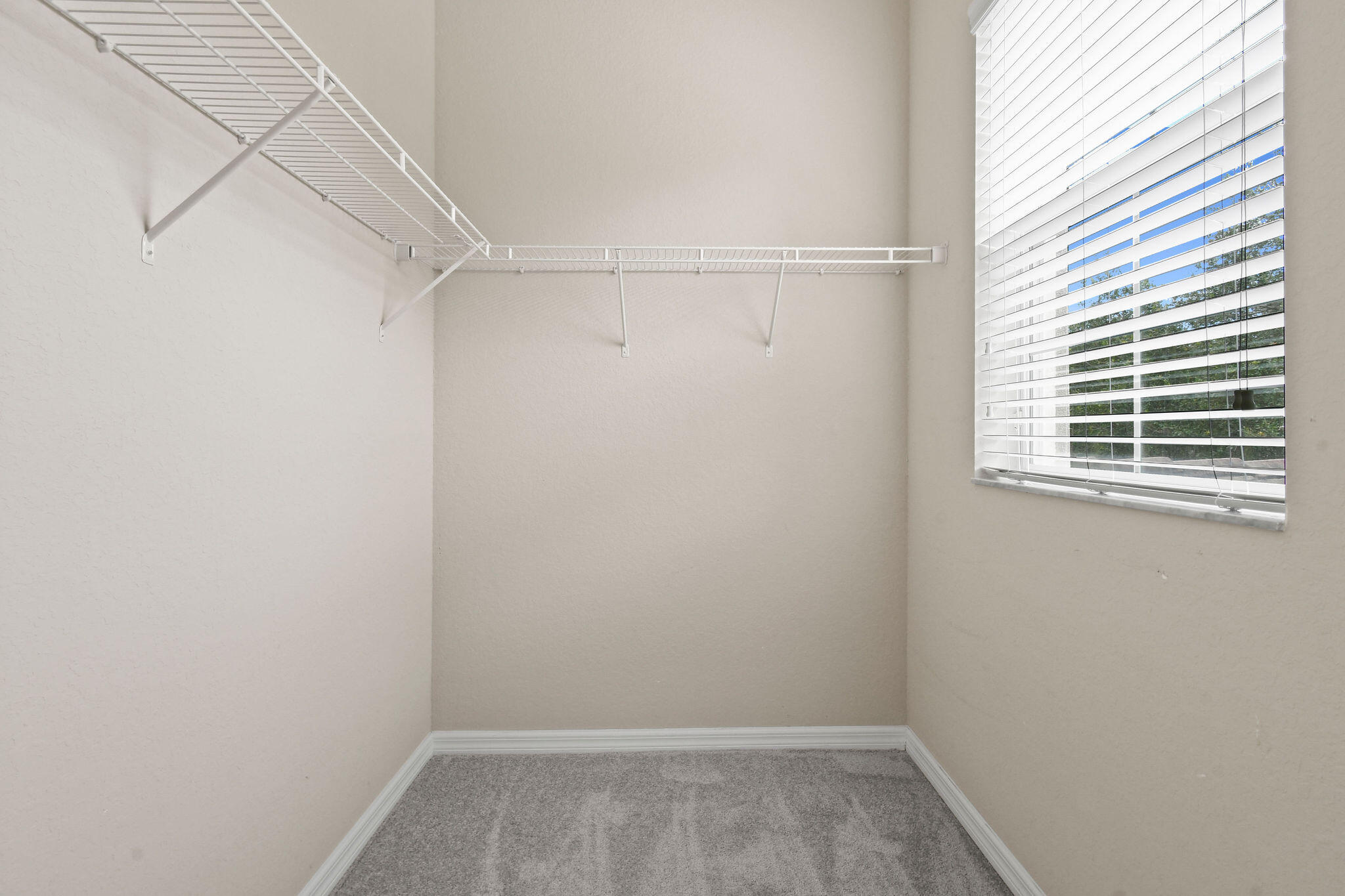 111 Tullamore Avenue Jupiter, FL 33458 - Photo 37 of 63 a view of a room with racks on the wall