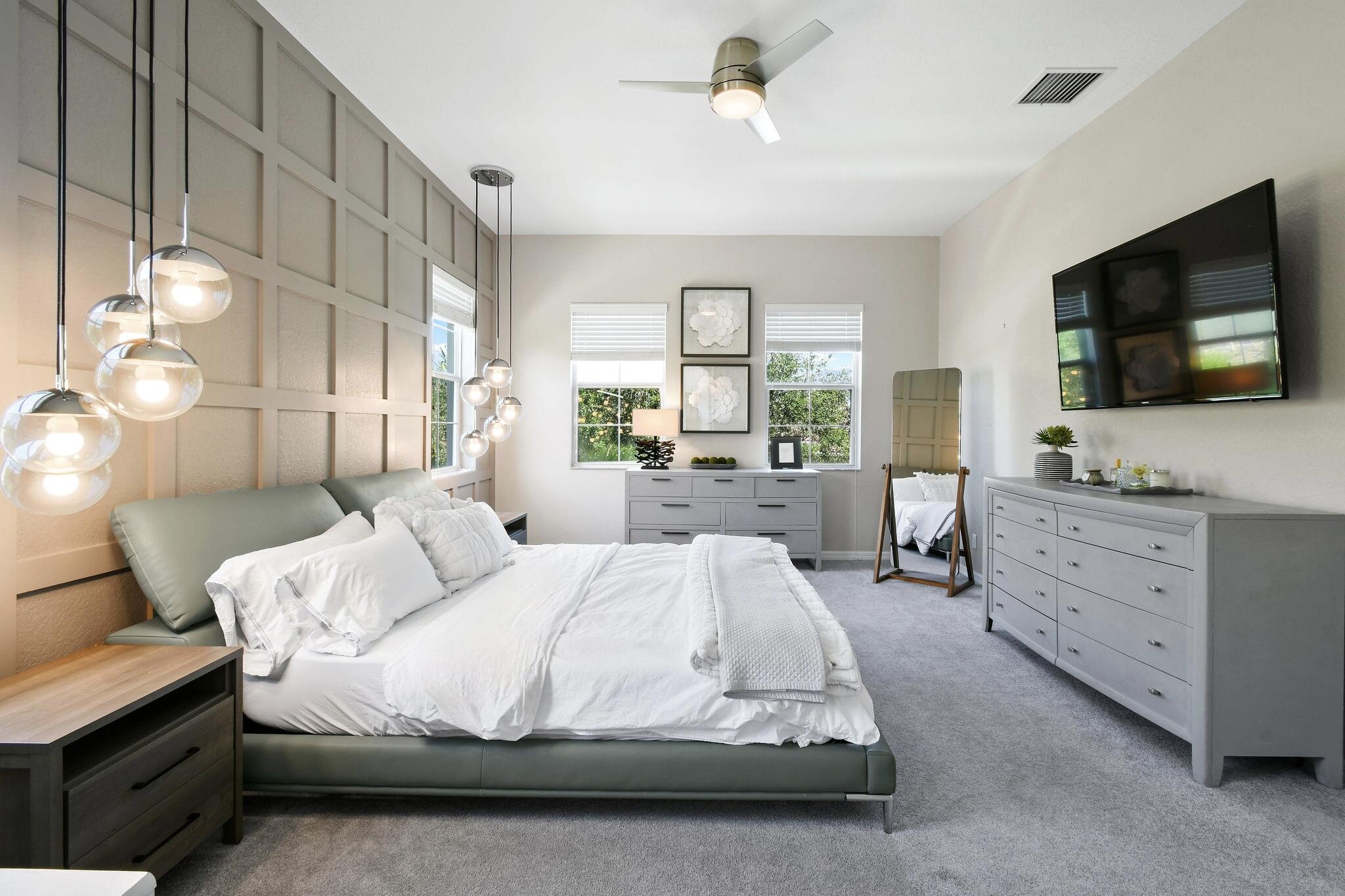 111 Tullamore Avenue Jupiter, FL 33458 - Photo 42 of 63 a spacious bedroom with a bed and a flat screen tv