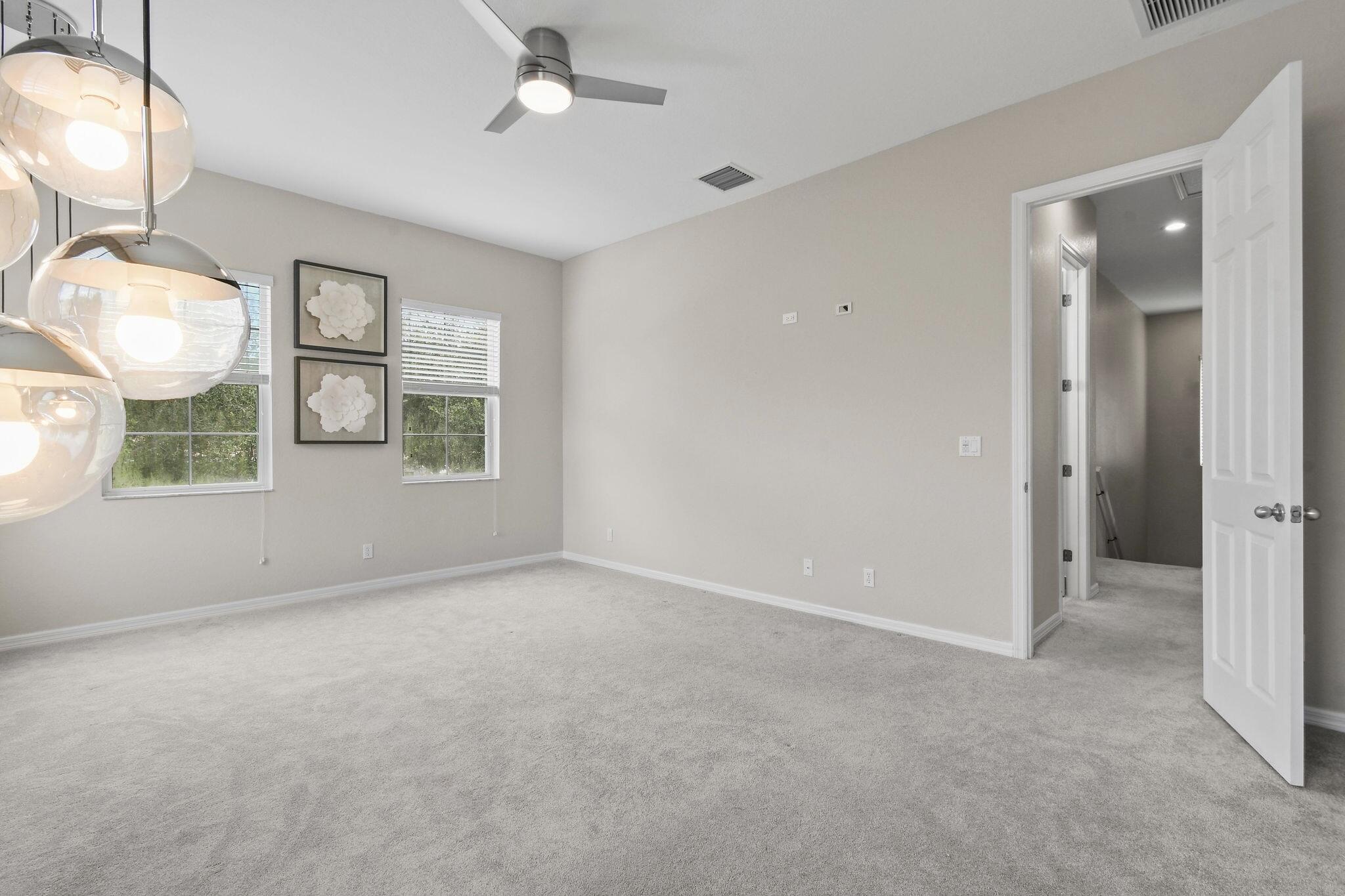 111 Tullamore Avenue Jupiter, FL 33458 - Photo 43 of 63 an empty room with windows and fan