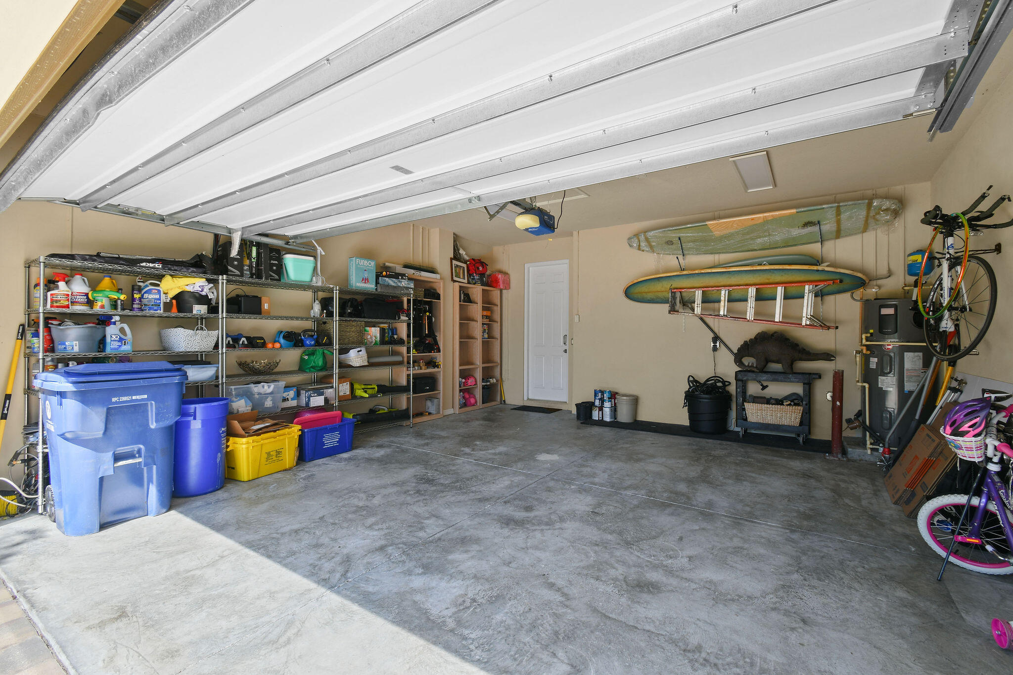 111 Tullamore Avenue Jupiter, FL 33458 - Photo 52 of 63 a view of a garage with a bike and car