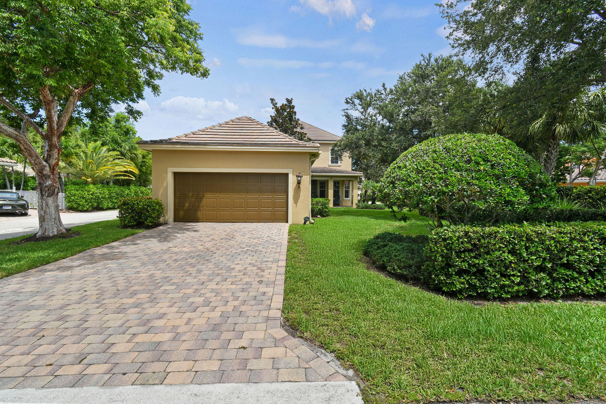 111 Tullamore Avenue Jupiter, FL 33458 - Photo 56 of 63 a front view of a house with a yard and trees