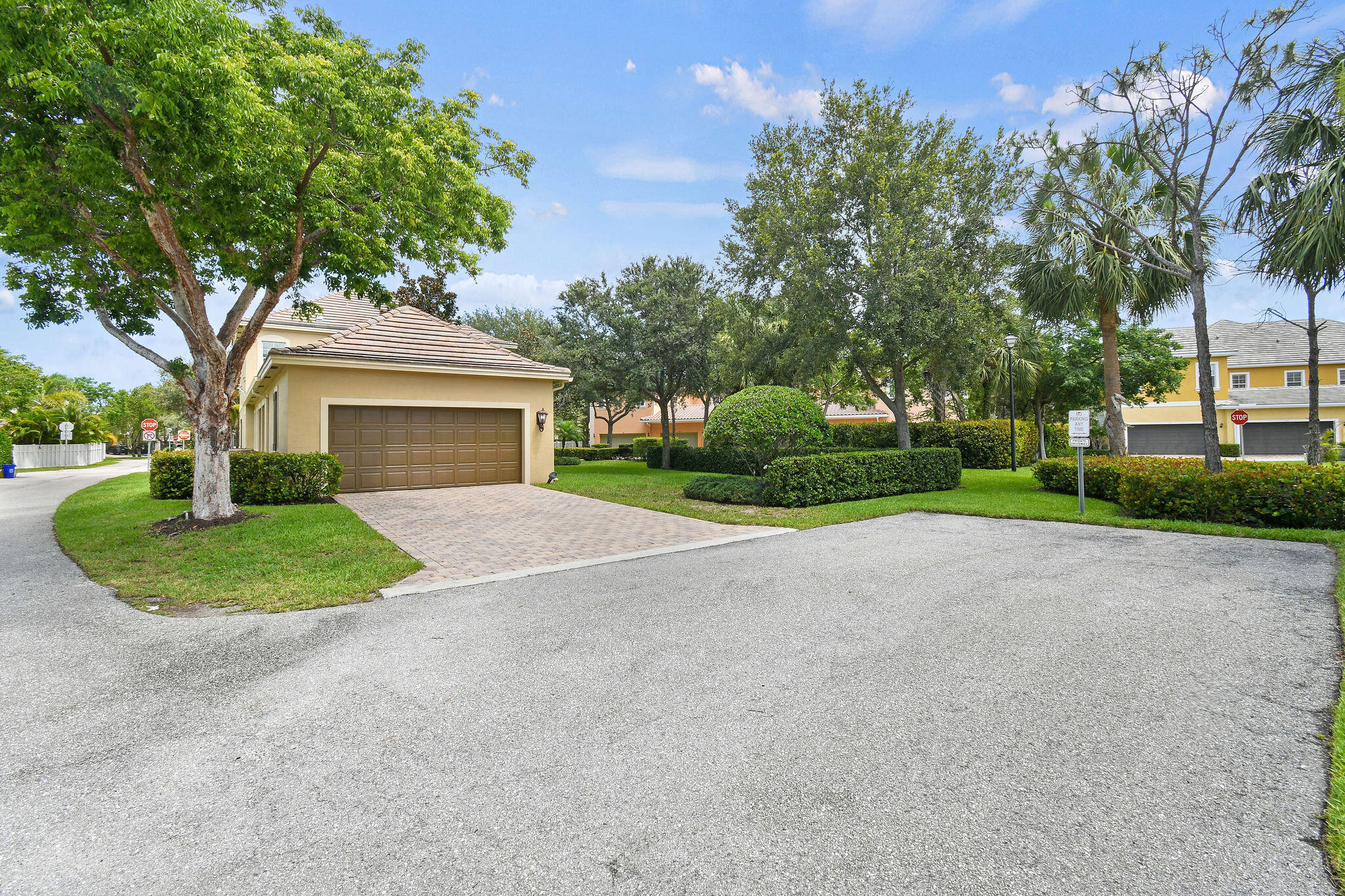 111 Tullamore Avenue Jupiter, FL 33458 - Photo 57 of 63 a front view of a house with a yard and garage
