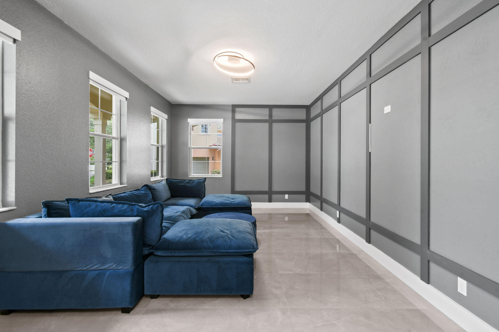 111 Tullamore Avenue Jupiter, FL 33458 - Photo 8 of 63 a living room with furniture and a large window