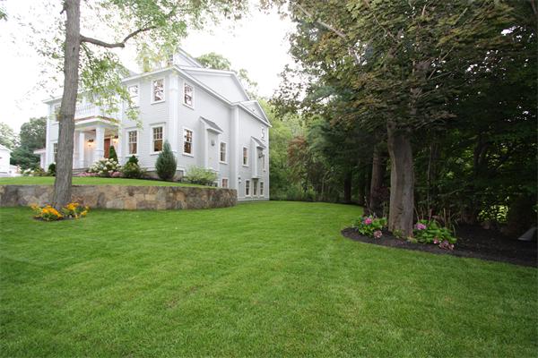 7 Royalston Road Wellesley, MA 02481 - Photo 6 of 30 a view of a white house next to a yard with big trees