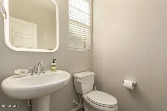 a bathroom with a sink a mirror and a toilet