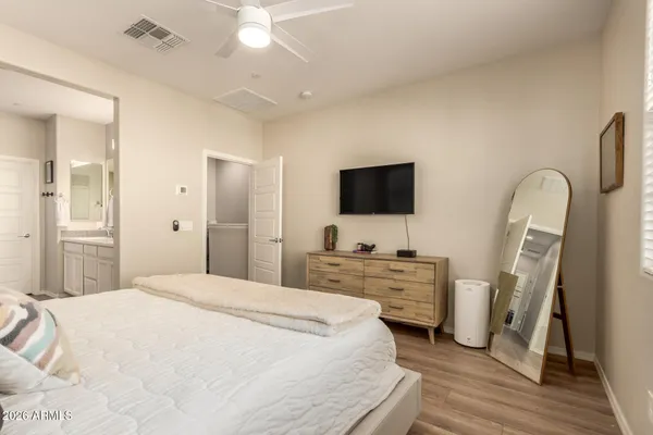 a bedroom with a bed and a flat screen tv