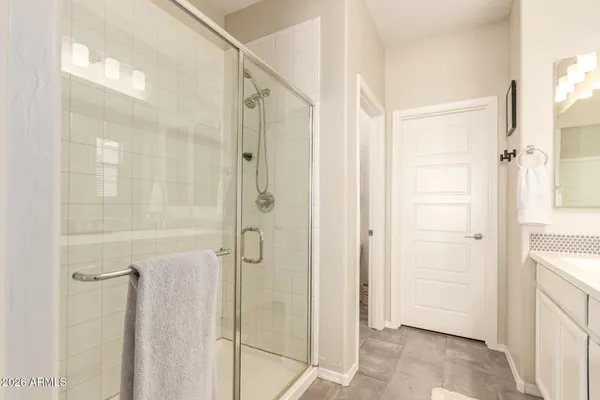 a bathroom with a shower and a glass door