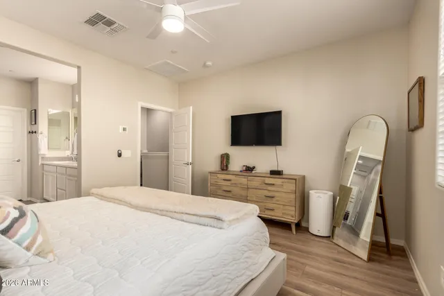 a bedroom with a bed and a flat screen tv