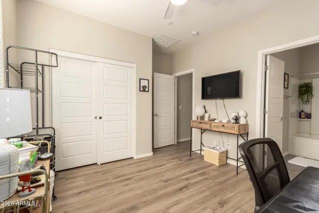 a view of a workspace with furniture and a flat screen tv