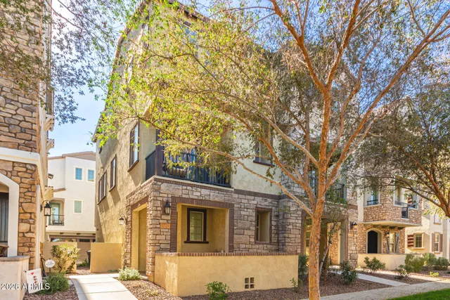 a front view of a building with a tree
