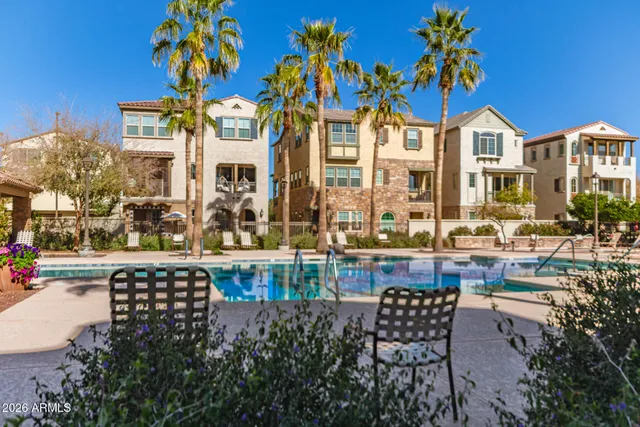 a view of a patio with couches table and chairs potted plants and palm tree