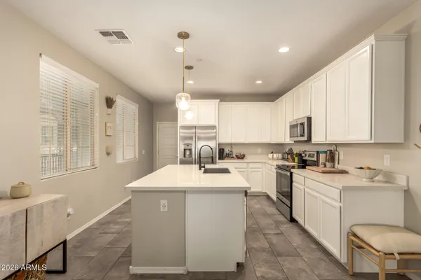 a kitchen with a sink window and cabinets
