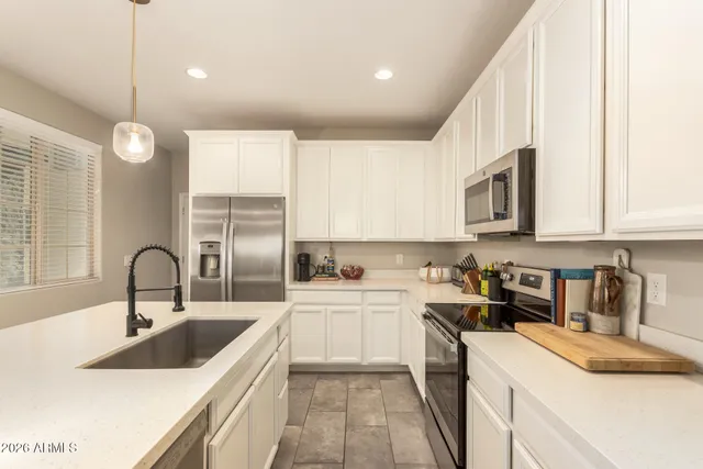 a kitchen with a sink stove top oven and refrigerator