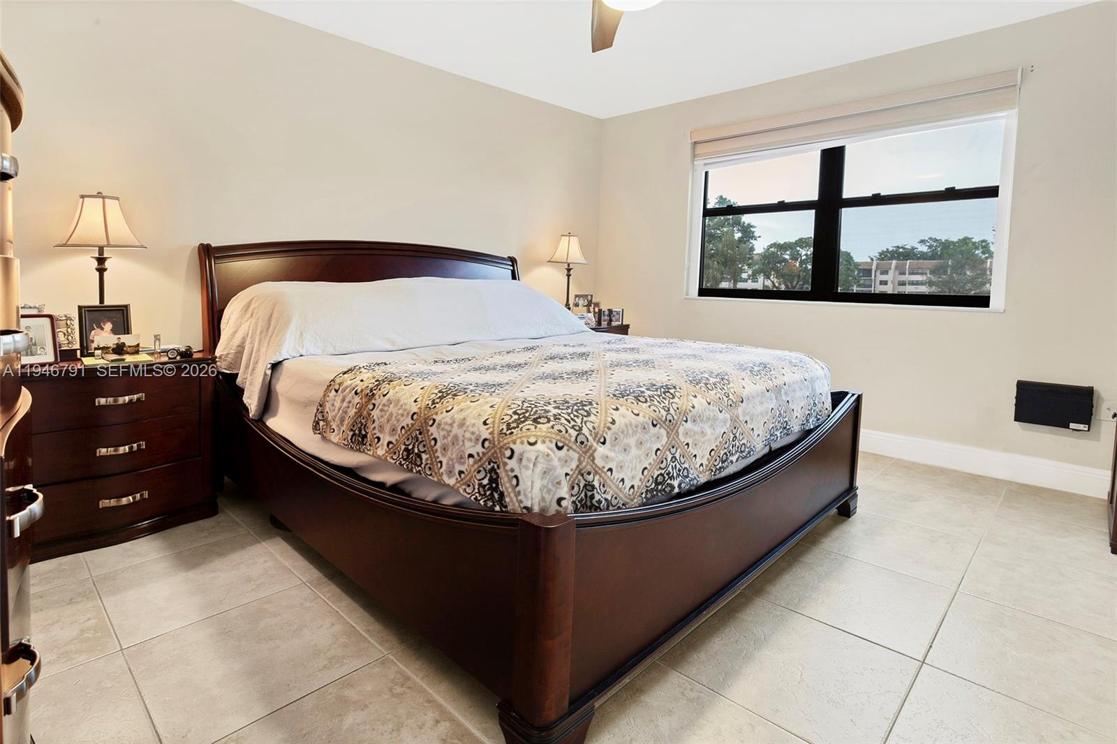 2941 North Nob Hill Road, Unit 208 Sunrise, FL 33322 - Photo 14 of 40 a bed sitting in a bedroom next to a window