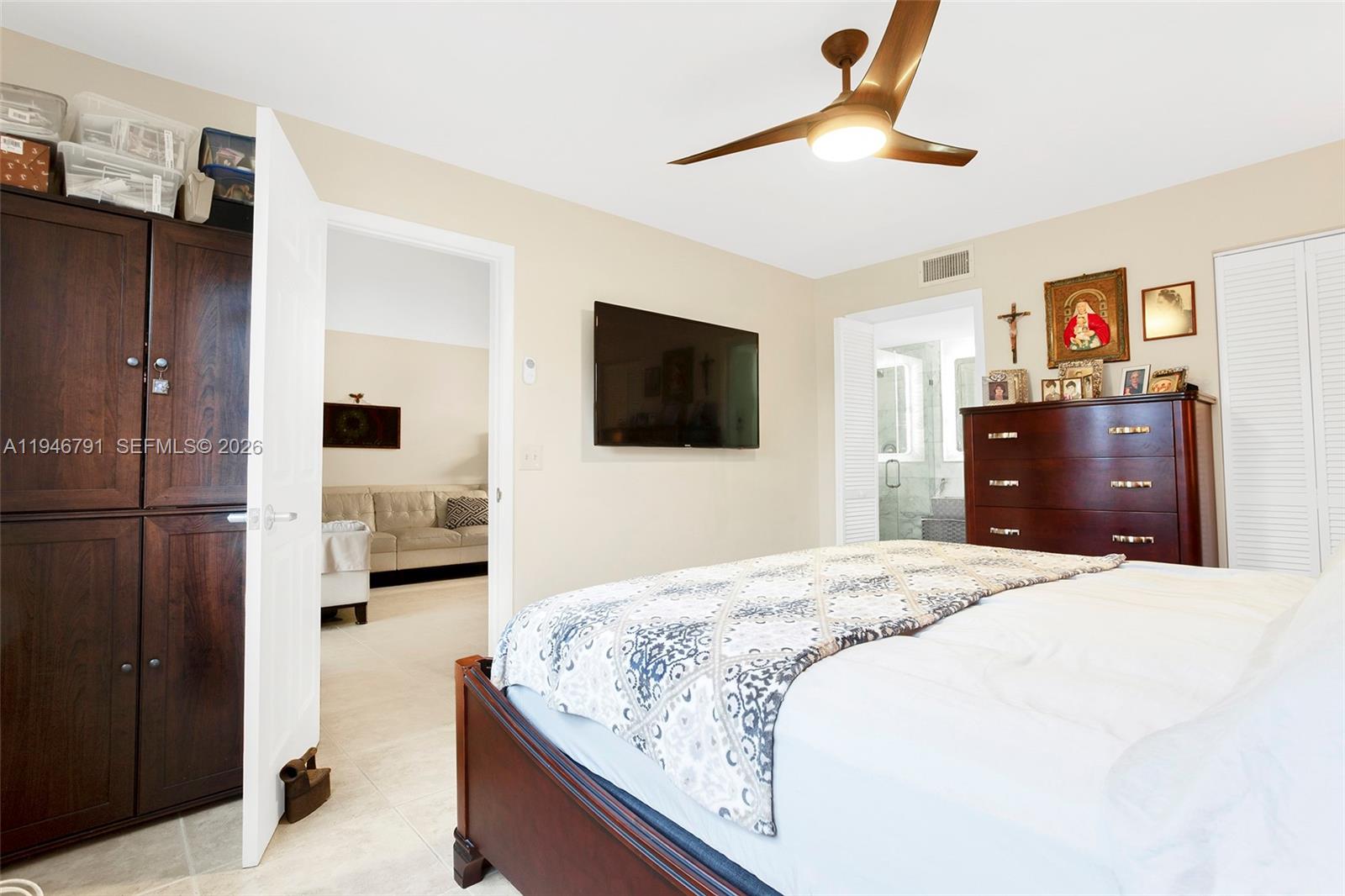 2941 North Nob Hill Road, Unit 208 Sunrise, FL 33322 - Photo 16 of 40 a bedroom with a bed and a flat screen tv