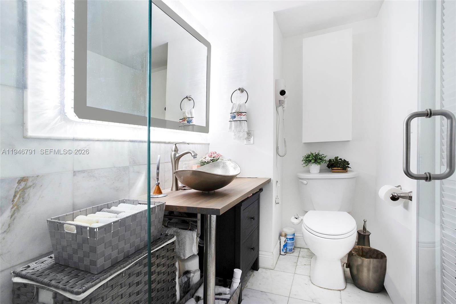 2941 North Nob Hill Road, Unit 208 Sunrise, FL 33322 - Photo 18 of 40 a bathroom with a sink toilet and mirror