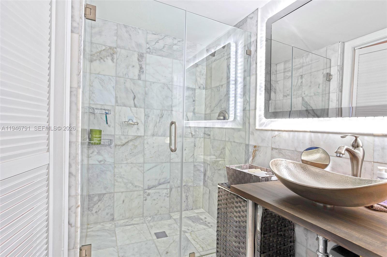 2941 North Nob Hill Road, Unit 208 Sunrise, FL 33322 - Photo 19 of 40 a bathroom with a sink and a mirror