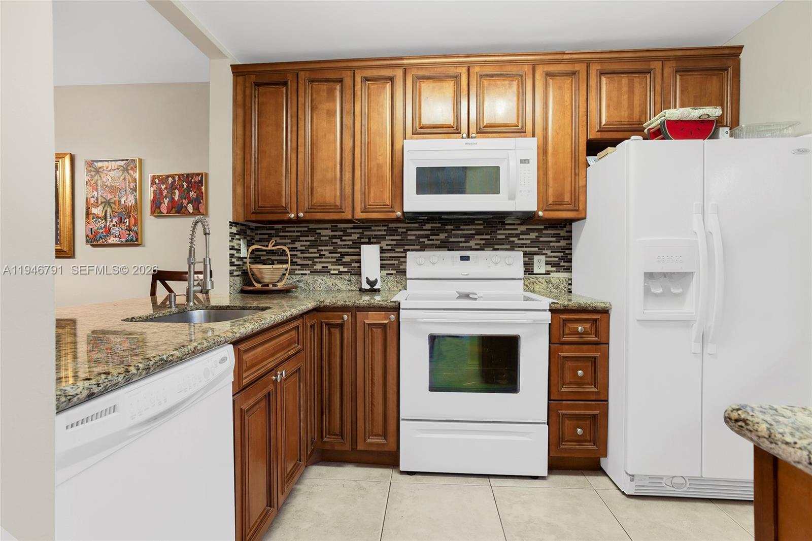 2941 North Nob Hill Road, Unit 208 Sunrise, FL 33322 - Photo 23 of 40 a kitchen with a stove a sink and a refrigerator