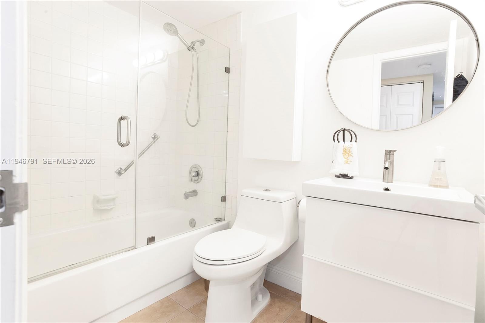 2941 North Nob Hill Road, Unit 208 Sunrise, FL 33322 - Photo 26 of 40 a bathroom with a sink a toilet and shower