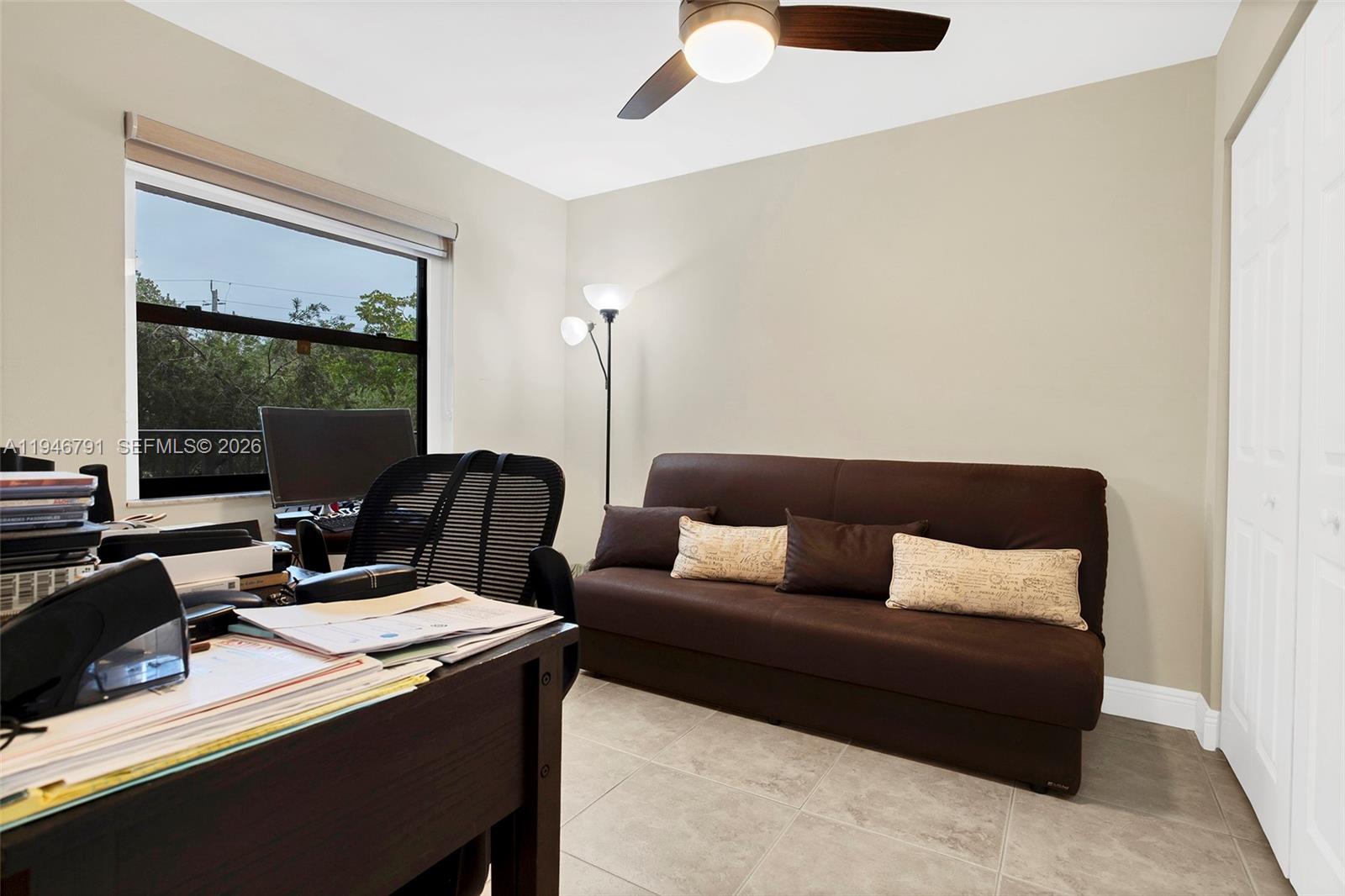 2941 North Nob Hill Road, Unit 208 Sunrise, FL 33322 - Photo 28 of 40 a living room with furniture and a floor to ceiling window