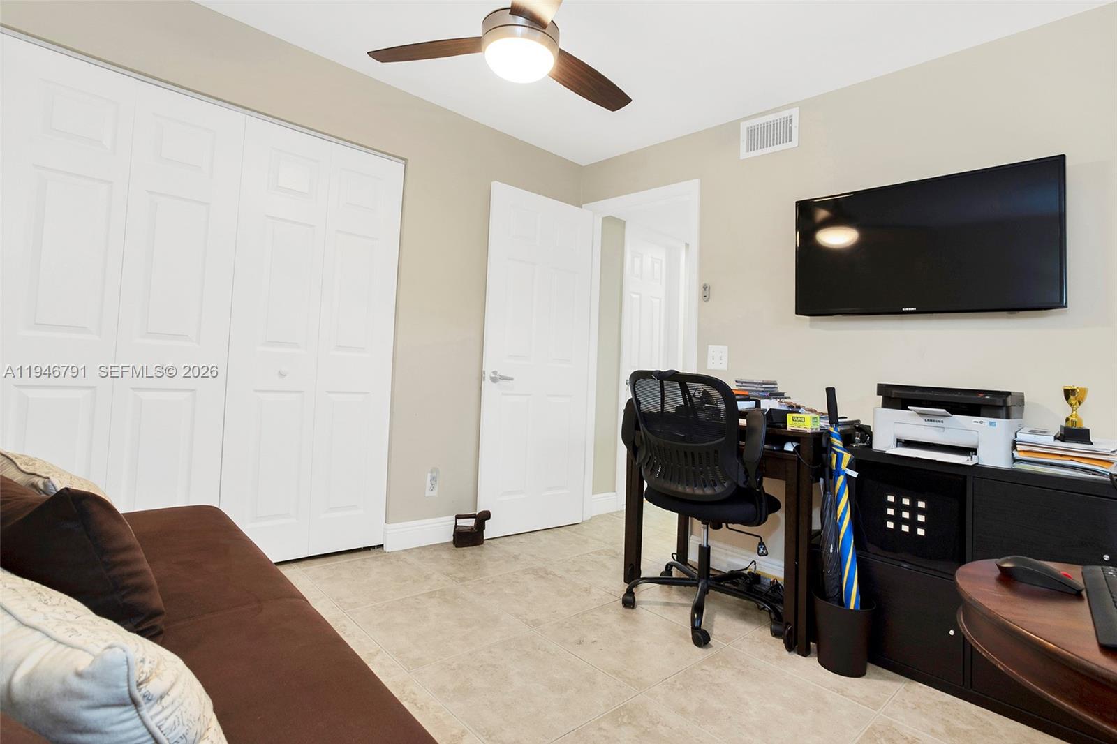 2941 North Nob Hill Road, Unit 208 Sunrise, FL 33322 - Photo 30 of 40 a living room with furniture and a flat screen tv