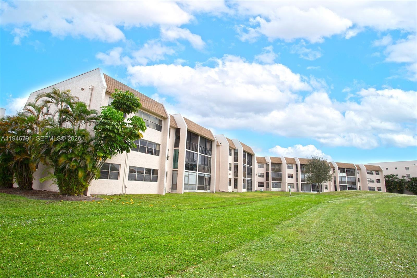 2941 North Nob Hill Road, Unit 208 Sunrise, FL 33322 - Photo 3 of 40 a view of a building with a yard