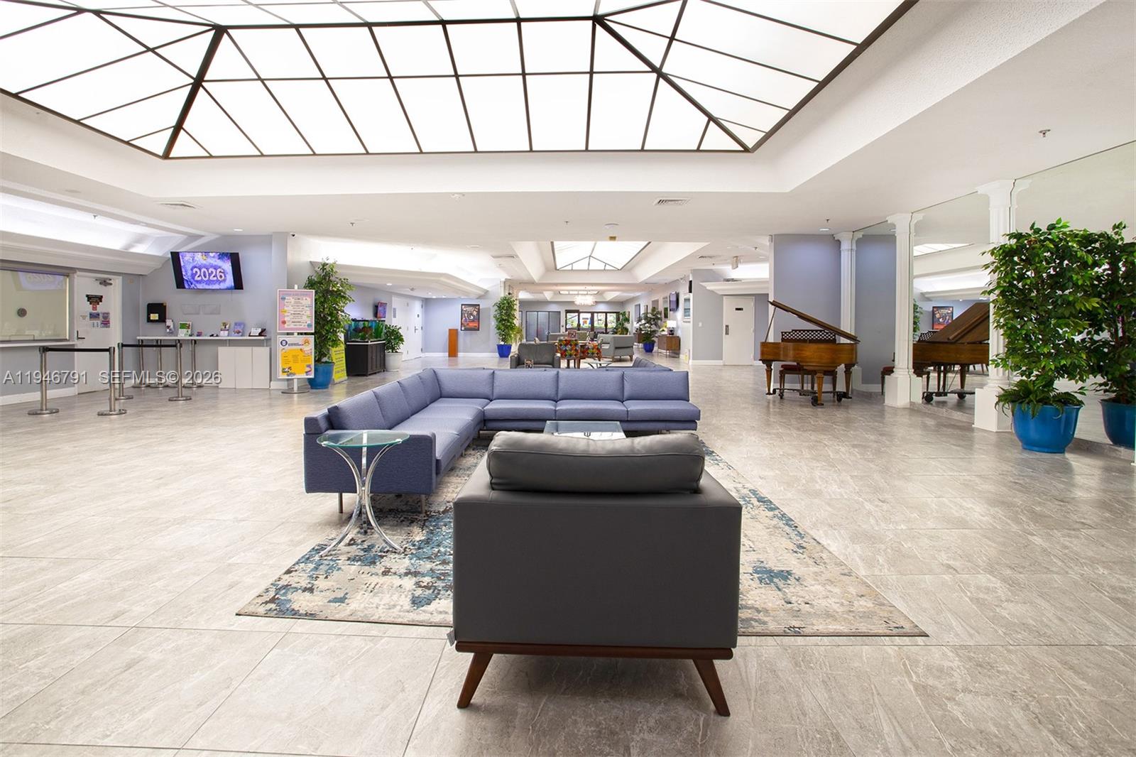 2941 North Nob Hill Road, Unit 208 Sunrise, FL 33322 - Photo 34 of 40 a living room with furniture and a chandelier