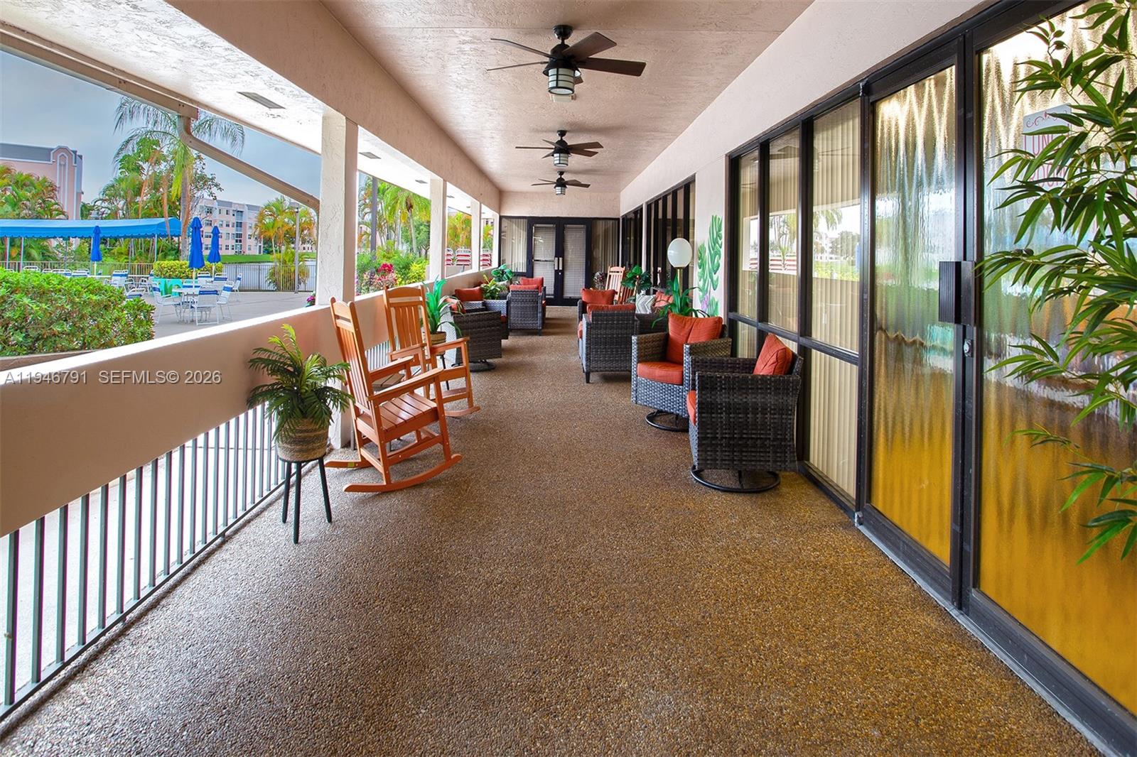 2941 North Nob Hill Road, Unit 208 Sunrise, FL 33322 - Photo 39 of 40 a living room with furniture and a floor to ceiling window