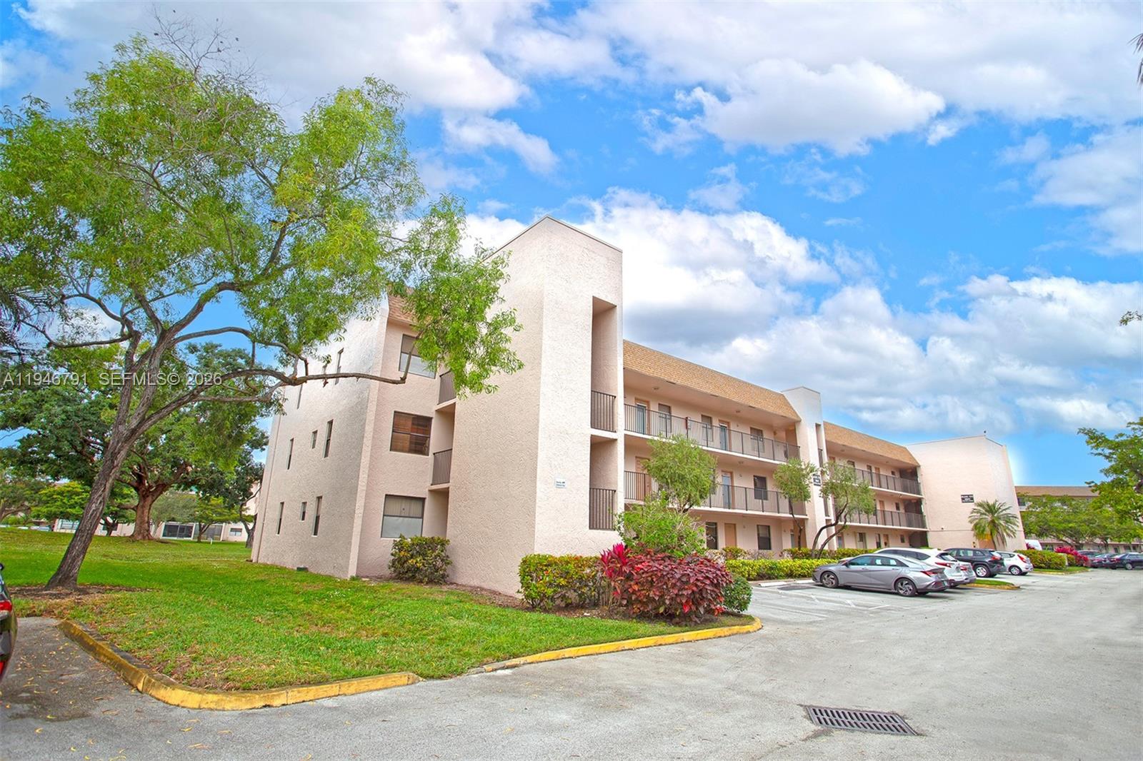 2941 North Nob Hill Road, Unit 208 Sunrise, FL 33322 - Photo 4 of 40 a front view of a building with garden
